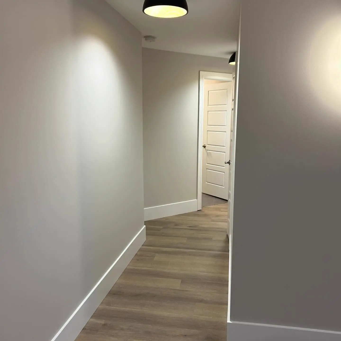 Hallway with painted walls, white baseboards and flooring, a PRO G2 project